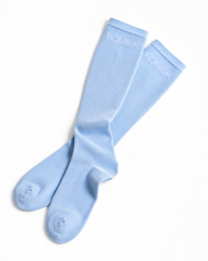 Pair of equisk light blue socks on a white background